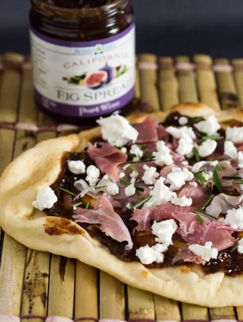 Indian flatbread makes a great crust for pizza! This na'an pizza is topped with fig jam, tangy goat cheese and salty prosciutto.