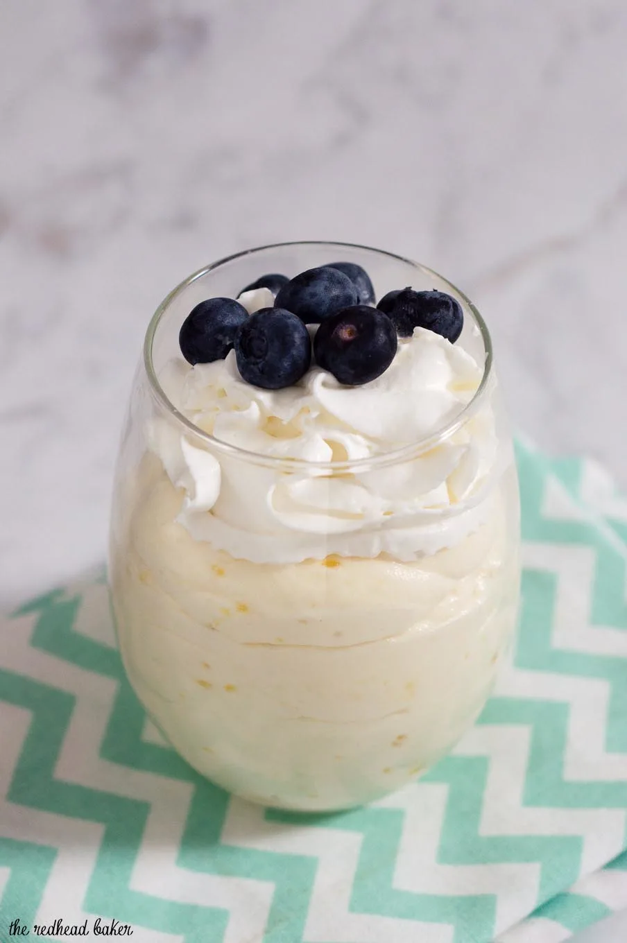 Meyer lemon mousse topped with fresh berries combines the curd of tangy-sweet meyer lemons with whipped cream for a flavorful, light dessert. #ProgressiveEats