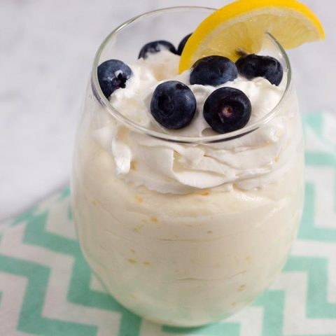 Meyer lemon mousse topped with fresh berries combines the curd of tangy-sweet meyer lemons with whipped cream for a flavorful, light dessert. #ProgressiveEats