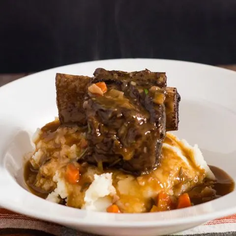 Beef short ribs become fall-off-the-bone tender in a braise of red wine, beef stock, and garlic. Serve over mashed potatoes for a true comfort meal.