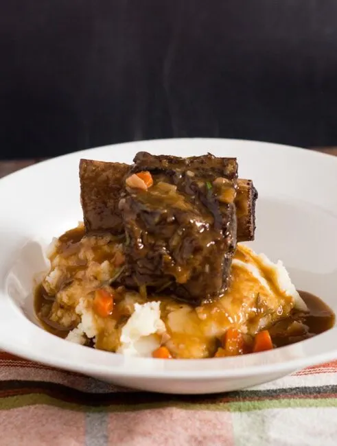 Beef short ribs become fall-off-the-bone tender in a braise of red wine, beef stock, and garlic. Serve over mashed potatoes for a true comfort meal.