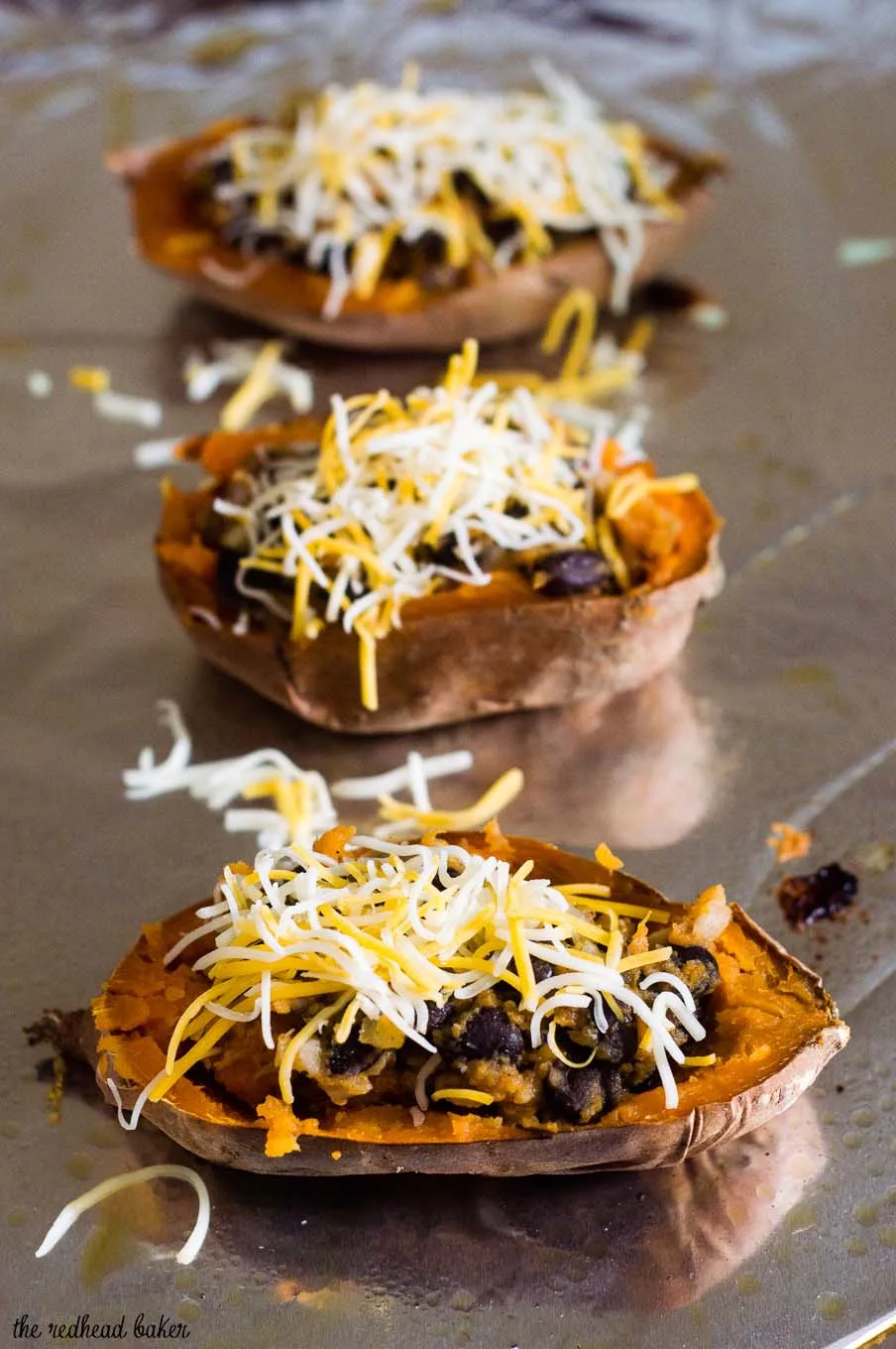 Twice-baked sweet potatoes are stuffed with a mixture of mashed sweet potatoes, black beans, onion, garlic and spices, and topped with melty Borden® Cheese for a healthier vegetarian dinner. #BordenCheeseLove #Ad