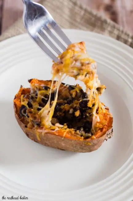 Twice-baked sweet potatoes are stuffed with a mixture of mashed sweet potatoes, black beans, onion, garlic and spices, and topped with melty Borden&reg; Cheese for a healthier vegetarian dinner. #BordenCheeseLove #Ad