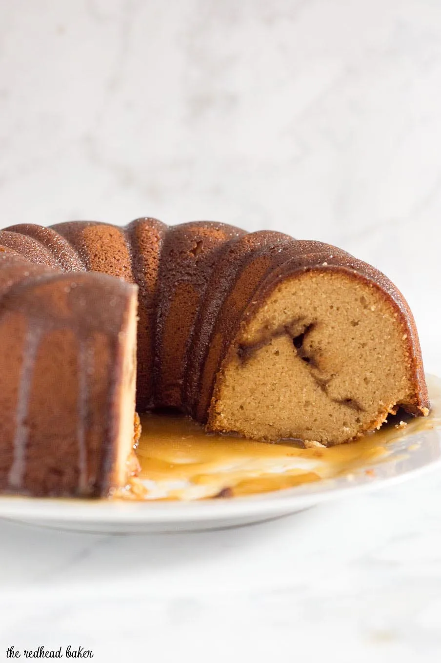 Apple butter pound cake has delicious apple flavor with hints of cinnamon, a ripple of apple butter, and a creamy caramel glaze.