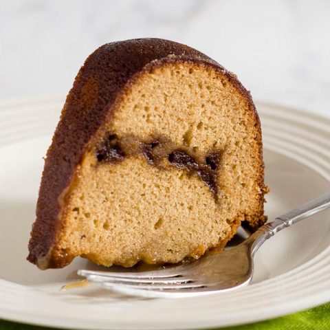 Apple butter pound cake has delicious apple flavor with hints of cinnamon, a ripple of apple butter, and a creamy caramel glaze.