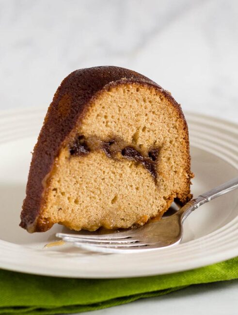 Apple butter pound cake has delicious apple flavor with hints of cinnamon, a ripple of apple butter, and a creamy caramel glaze.