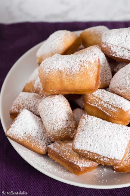 Mardi Gras means it's time for beignets! This is a classic New Orleans recipe, deep-fried then coated in powdered sugar, and served with raspberry jam.