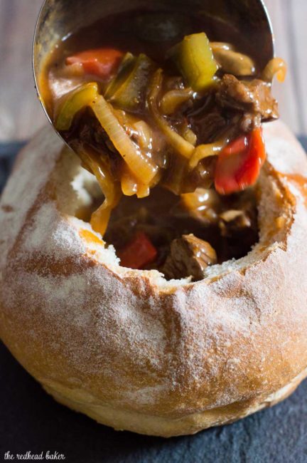 Philly cheesesteak chili has all the flavors of a traditional cheesesteak sandwich, topped with cheese and served in a hollowed-out bread bowl.