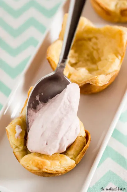 Mini raspberry mousse tartlets are full of spring flavor! Raspberry curd gives them a spring pink tint, and they are finished with a dollop of Reddi-wip&reg;! #SpringReddi #ad