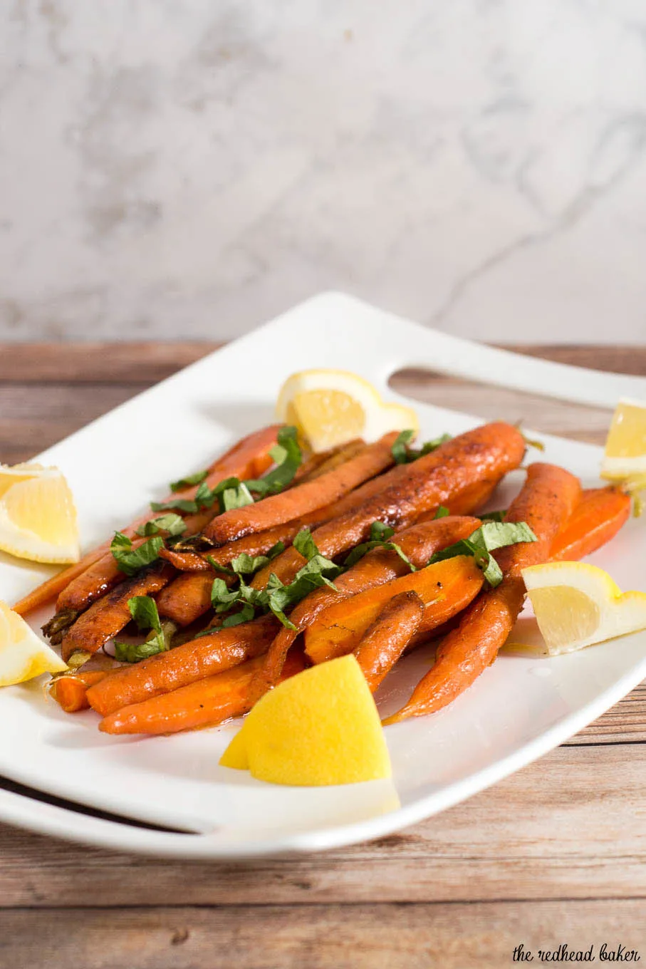 Butter-braised spring carrots are a simple yet flavorful side dish. A garnish of fresh basil complements the sweeter carrots perfectly.