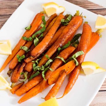 Butter-braised spring carrots are a simple yet flavorful side dish. A garnish of fresh basil complements the sweeter carrots perfectly.