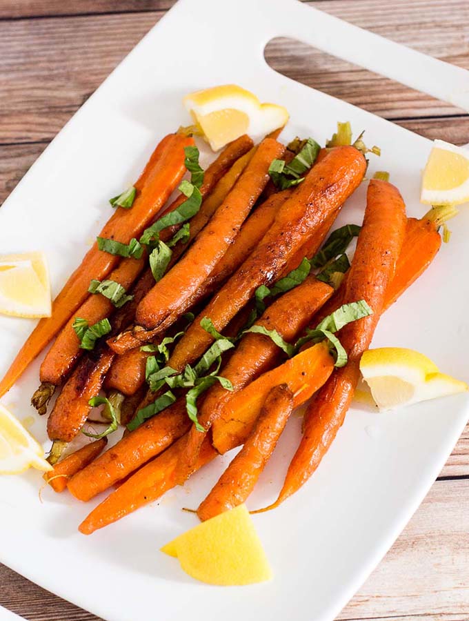 Butter-braised spring carrots are a simple yet flavorful side dish. A garnish of fresh basil complements the sweeter carrots perfectly.