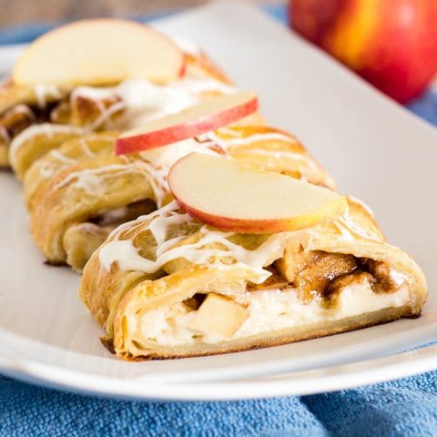 An apple Danish braid is a delicious fruit-filled pastry to serve at brunch. Flaky pastry covers sauteed cinnamon apples and sweetened cream cheese. #BrunchWeek