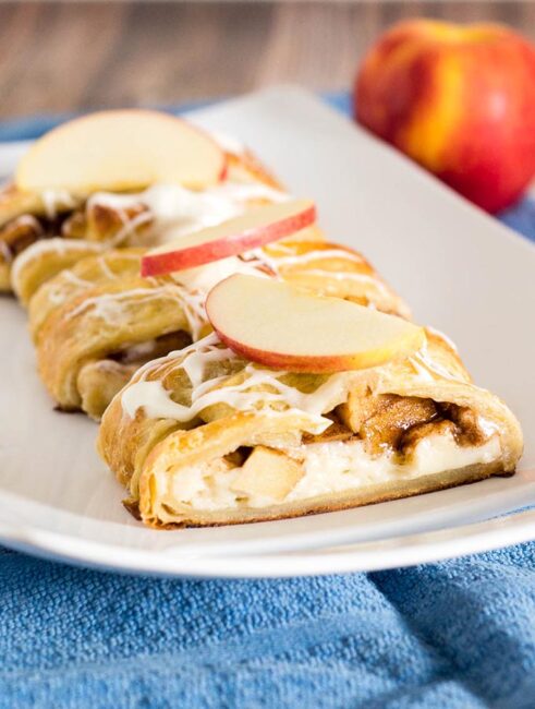 An apple Danish braid is a delicious fruit-filled pastry to serve at brunch. Flaky pastry covers sauteed cinnamon apples and sweetened cream cheese. #BrunchWeek