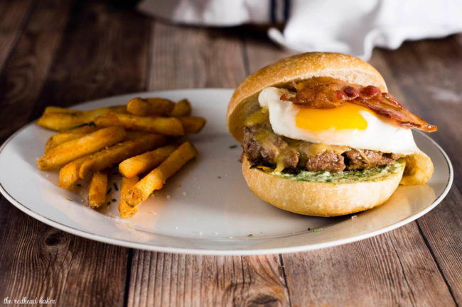 These French Bistro Burgers are full of over-the-top flavor: an herb aioli, smoked gouda cheese, bacon and a sunnyside up egg. Serve with rosemary fries or a frisee salad. #BurgerMonth #GirlCarnivore