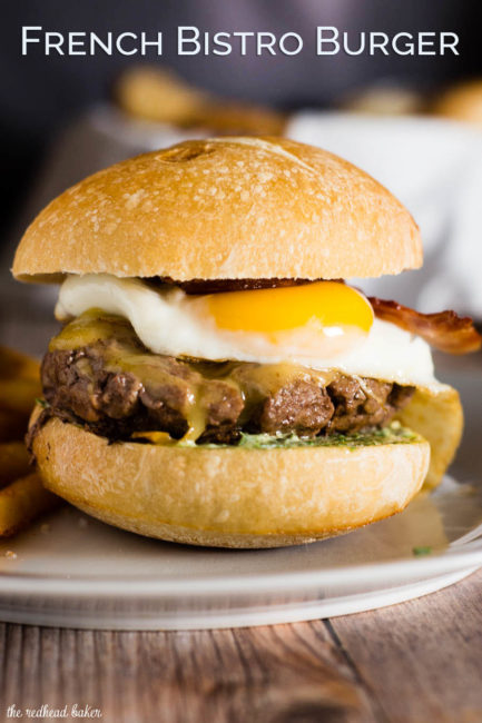 These French Bistro Burgers are full of over-the-top flavor: an herb aioli, smoked gouda cheese, bacon and a sunnyside up egg. Serve with rosemary fries or a frisee salad. #BurgerMonth #GirlCarnivore