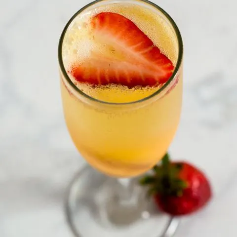 Mango sorbet bellinis are made with just two ingredients, but using sorbet makes them just a little extra special. Top off with a fresh strawberry slice. #BrunchWeek