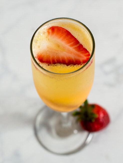 Mango sorbet bellinis are made with just two ingredients, but using sorbet makes them just a little extra special. Top off with a fresh strawberry slice. #BrunchWeek