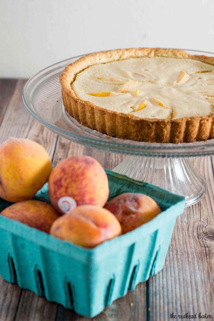 This peach custard tart has a crumbly cookie crust and a creamy custard filling loaded with tender peach slices. It's a delicious end to any meal! #BrunchWeek