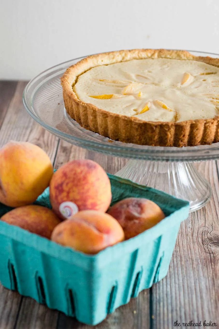 This peach custard tart has a crumbly cookie crust and a creamy custard filling loaded with tender peach slices. It's a delicious end to any meal! #BrunchWeek