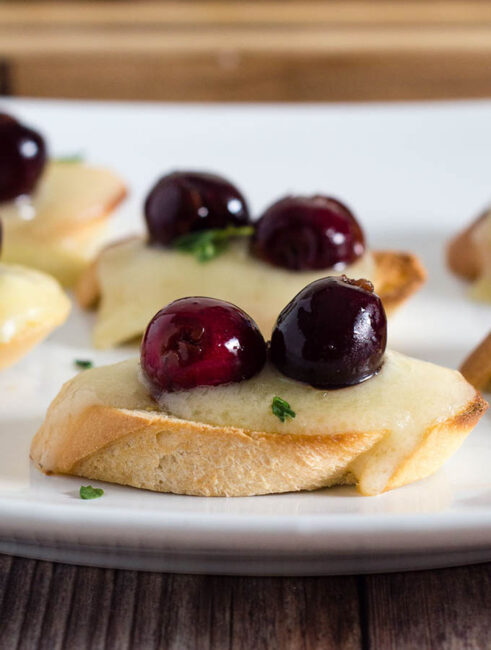 Tired of the same old appetizers? Try this cherry bruschetta — toasted baguette slices are topped with melted brie, beer-soaked cherries and fresh thyme.