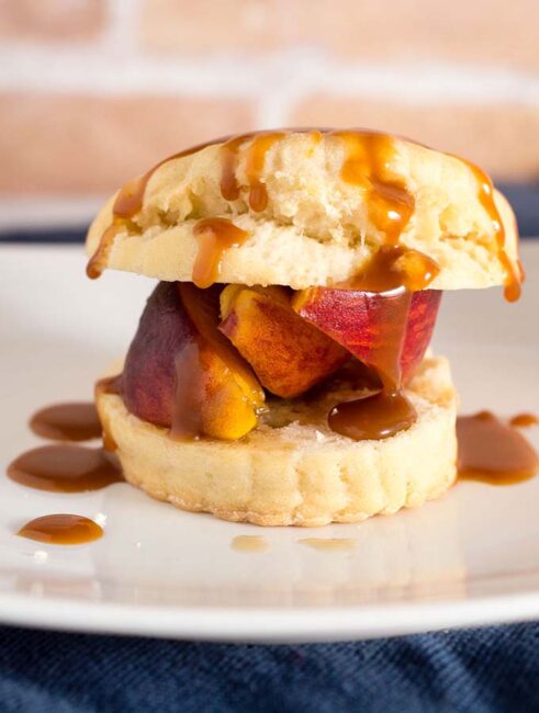 Like the classic strawberry version, peach shortcake combines a sweet biscuit with brandied brown-sugar peaches, and is topped off with a drizzle of salted caramel sauce. #CookoutWeek