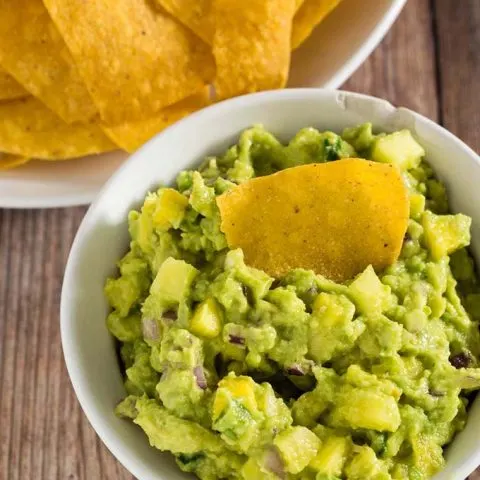 Tropical guacamole puts a sweet spin on a Mexican classic with the addition of pineapple and mango. Serve as a snack, appetizer or side dish!