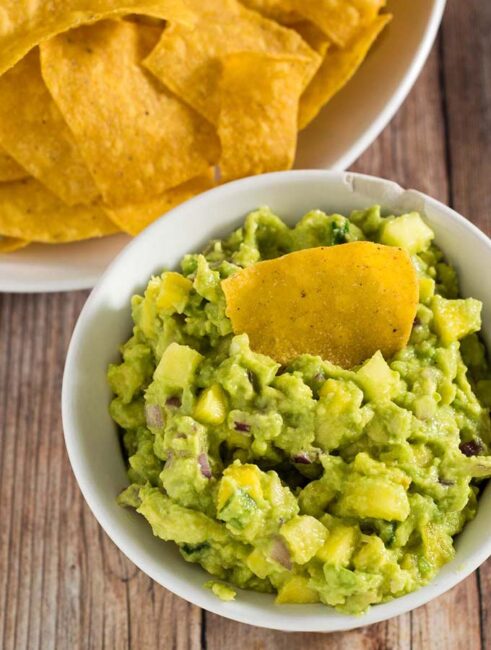 Tropical guacamole puts a sweet spin on a Mexican classic with the addition of pineapple and mango. Serve as a snack, appetizer or side dish!