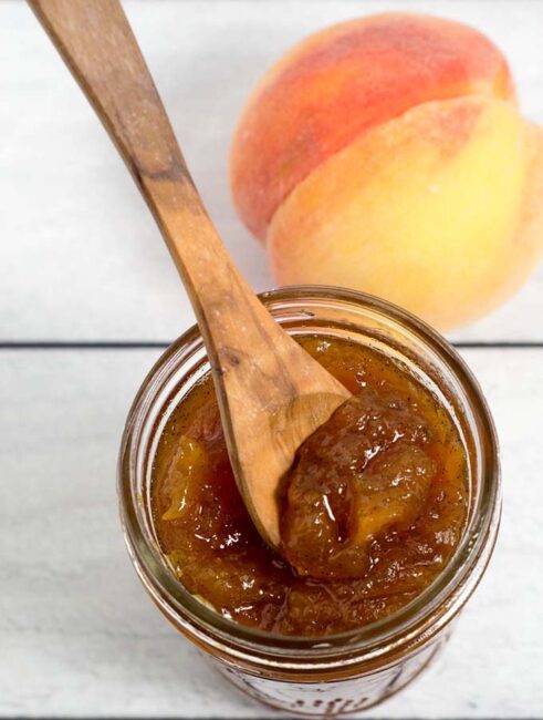 Peach vanilla jam sweetened with honey is canned using the waterbath method (no pectin needed!), so you can have a taste of summer all year long! 