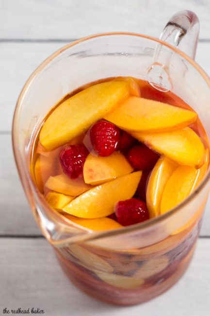 Fresh, sweet summer fruit balances dry white wine in this raspberry peach sangria. It's the perfect summer cocktail for any summer occasion.