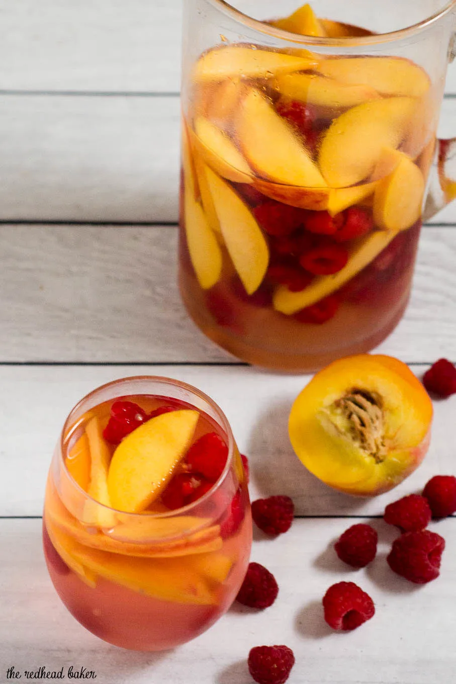 Fresh, sweet summer fruit balances dry white wine in this raspberry peach sangria. It's the perfect summer cocktail for any summer occasion.