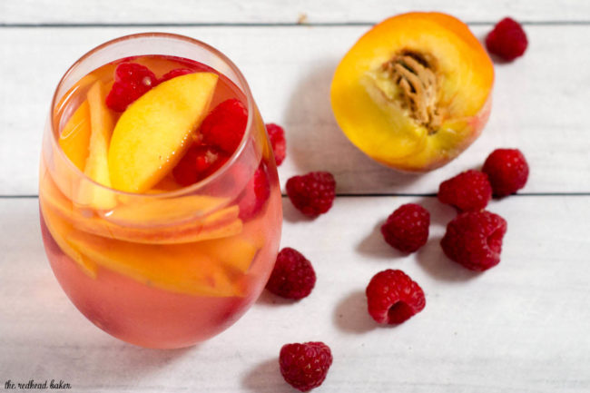 Fresh, sweet summer fruit balances dry white wine in this raspberry peach sangria. It's the perfect summer cocktail for any summer occasion.