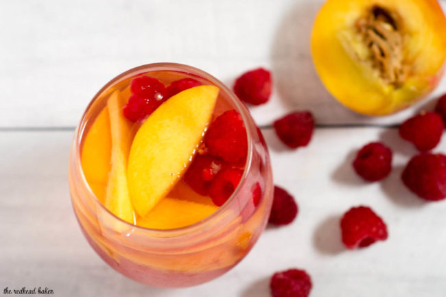 Fresh, sweet summer fruit balances dry white wine in this raspberry peach sangria. It's the perfect summer cocktail for any summer occasion.