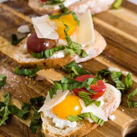 Bruschetta with marinated tomatoes and ricotta is an easy appetizer that epitomizes summer. Using multicolored cherry tomatoes adds visual interest. 