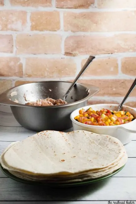 Chicken and summer veggie tostadas are loaded with lots of fresh farmers market vegetables and herbs. It's a healthy meal that's easy enough for any weeknight!