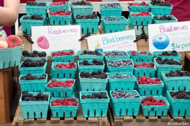 Raspberry lemon cupcakes are a delicious summer dessert. These fluffy cupcakes are filled with tart lemon curd and topped with silky buttercream flavored with raspberry puree.&nbsp;#FarmersMarketWeek