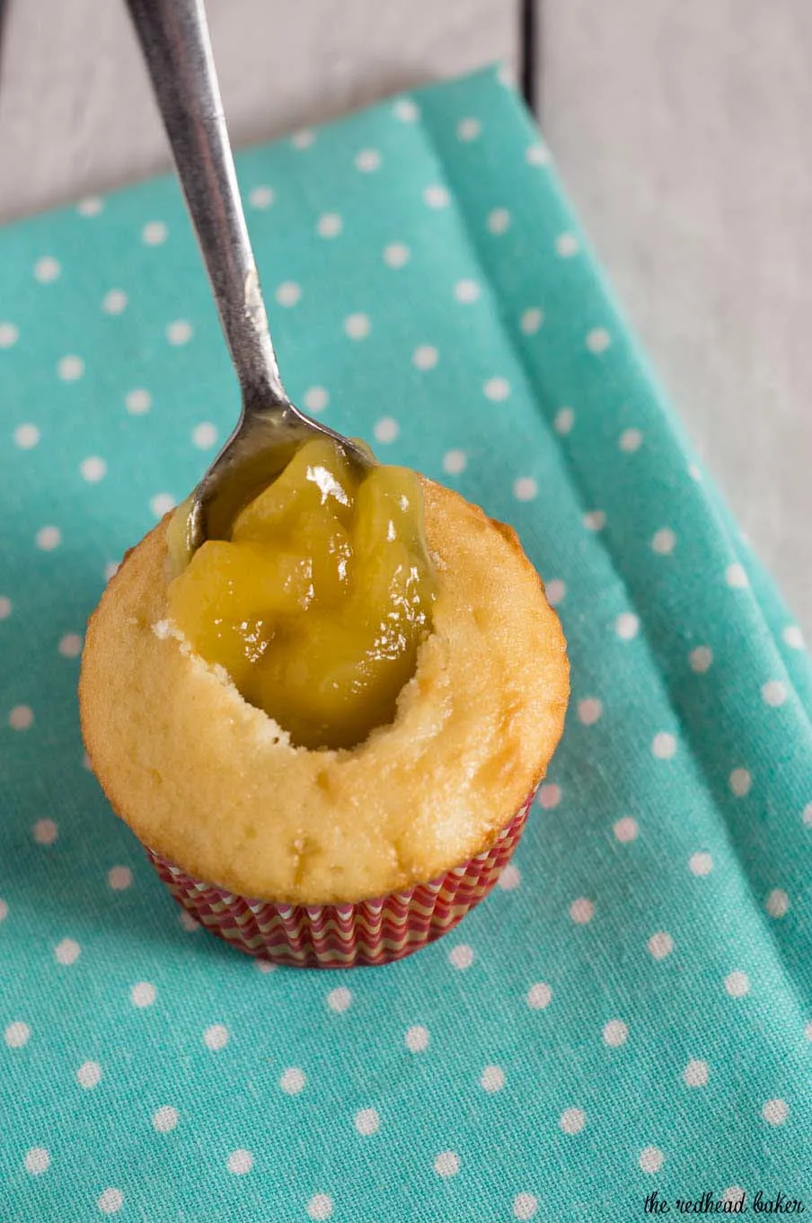 Raspberry lemon cupcakes are a delicious summer dessert. These fluffy cupcakes are filled with tart lemon curd and topped with silky buttercream flavored with raspberry puree. #FarmersMarketWeek