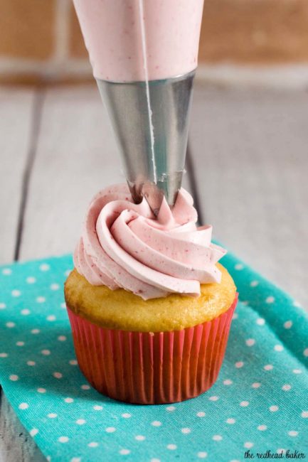 Raspberry lemon cupcakes are a delicious summer dessert. These fluffy cupcakes are filled with tart lemon curd and topped with silky buttercream flavored with raspberry puree. #FarmersMarketRecipes