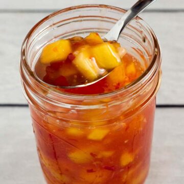 This sticky, sweet mango chili sauce is easy to make and so addictive! Use it to dip shrimp, chicken or fresh spring rolls. 