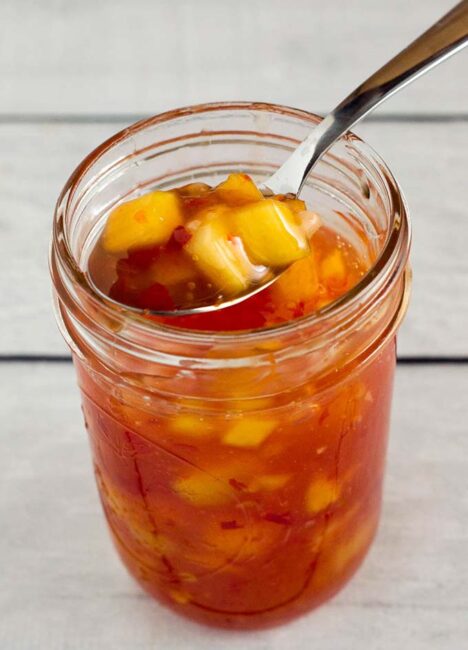 This sticky, sweet mango chili sauce is easy to make and so addictive! Use it to dip shrimp, chicken or fresh spring rolls. 