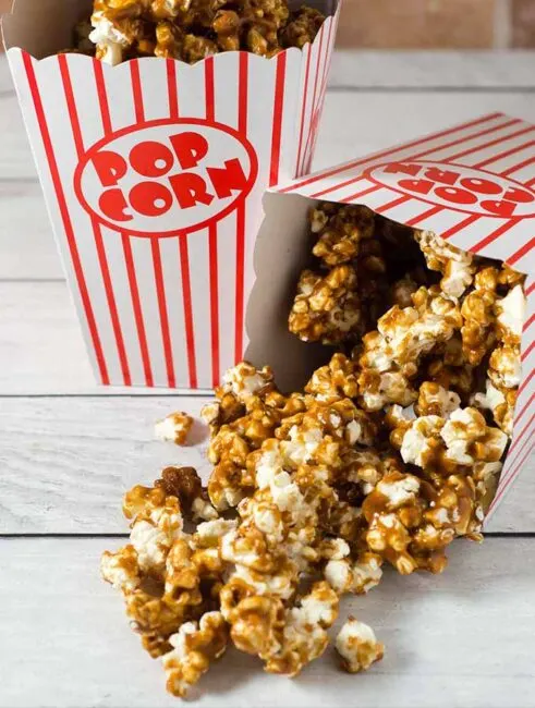 It's so easy to make your own buttery sweet caramel corn at home! This oldie-but-goodie snack will be a hit at any party.