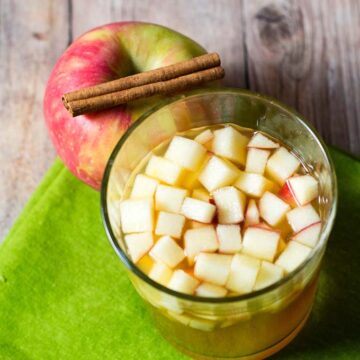 Cinnamon apple cider sangria is a delicious fall cocktail combining white wine, apple cider, apple brandy and cinnamon whiskey. #AppleWeek