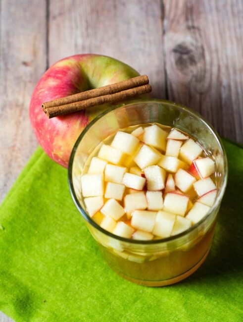 Cinnamon apple cider sangria is a delicious fall cocktail combining white wine, apple cider, apple brandy and cinnamon whiskey. #AppleWeek