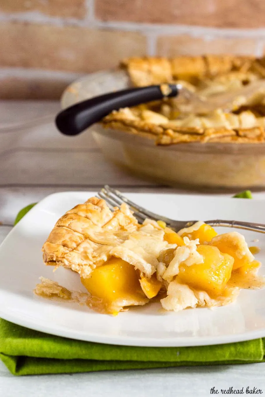 One slice of this mango peach pie is a tropical treat! Chunks of fresh fruit are lightly spiced with cinnamon, ginger and nutmeg.  #OXOGoodCookies #BakeADifference