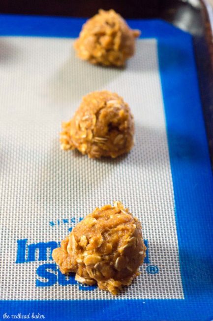 These chewy pumpkin oatmeal cookies are flavored with spices and nutty browned butter, and are loaded with caramel chips.  #PumpkinWeek