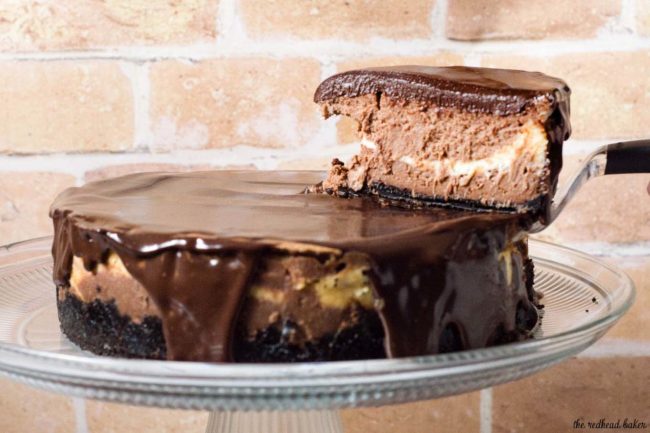 If chocolate cheesecake is good, triple chocolate cheesecake must be better! Layers of semisweet, white and milk chocolate cheesecake on a chocolate cookie crust are topped with a rich chocolate glaze. #Choctoberfest