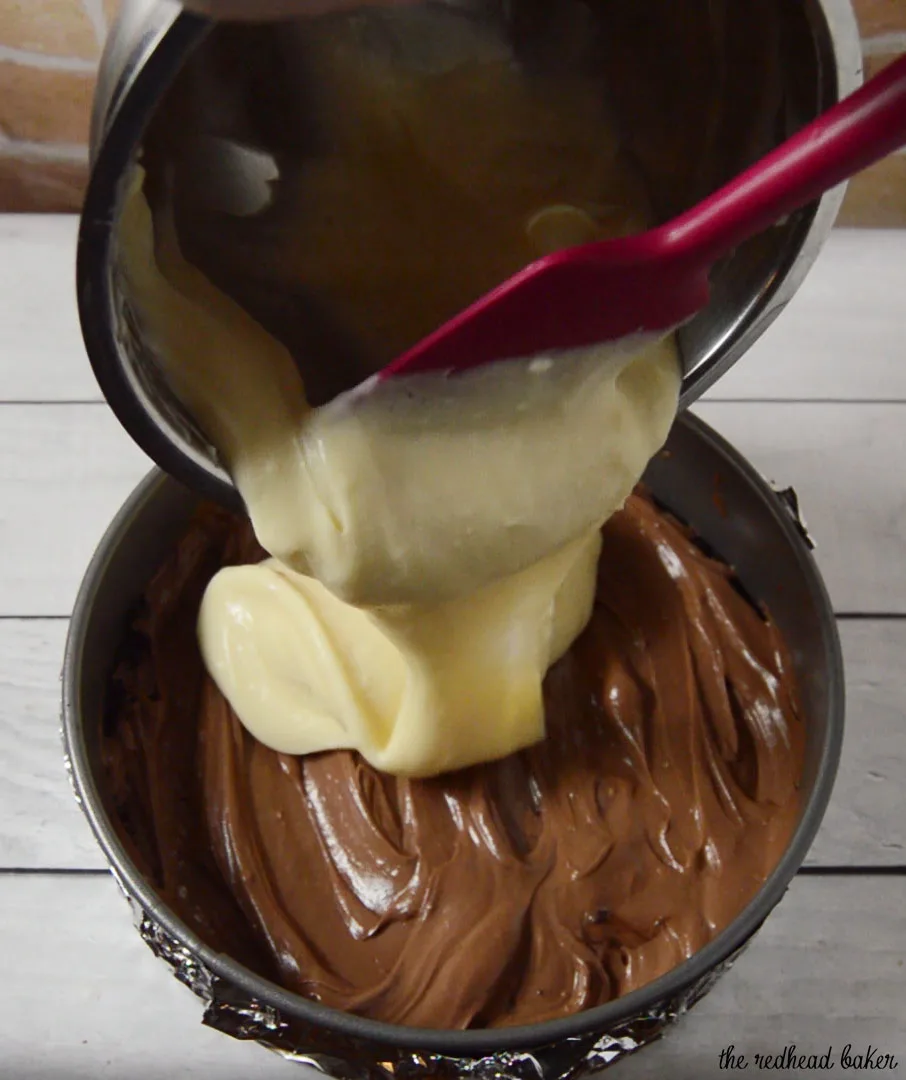 If chocolate cheesecake is good, triple chocolate cheesecake must be better! Layers of semisweet, white and milk chocolate cheesecake on a chocolate cookie crust are topped with a rich chocolate glaze. #Choctoberfest