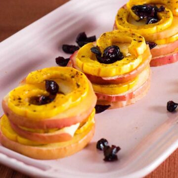 Delicata squash and apple stacks are a unique way to enjoy this fall produce. Seasoned with cinnamon and thyme, they blend sweet and savory flavors.