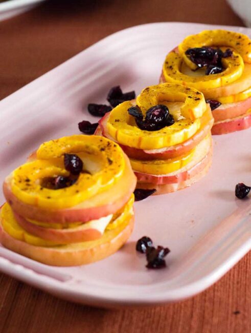 Delicata squash and apple stacks are a unique way to enjoy this fall produce. Seasoned with cinnamon and thyme, they blend sweet and savory flavors.