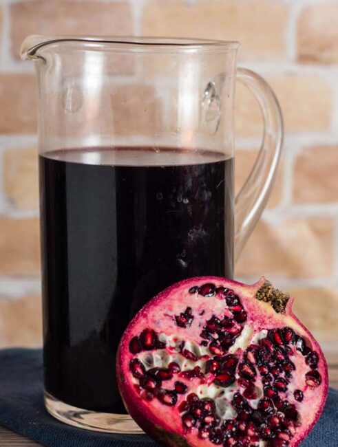 Spiced pomegranate red wine punch is a delicious cocktail for holidays and average days alike. Serve it warm or cold, garnished with a twist of orange rind. 